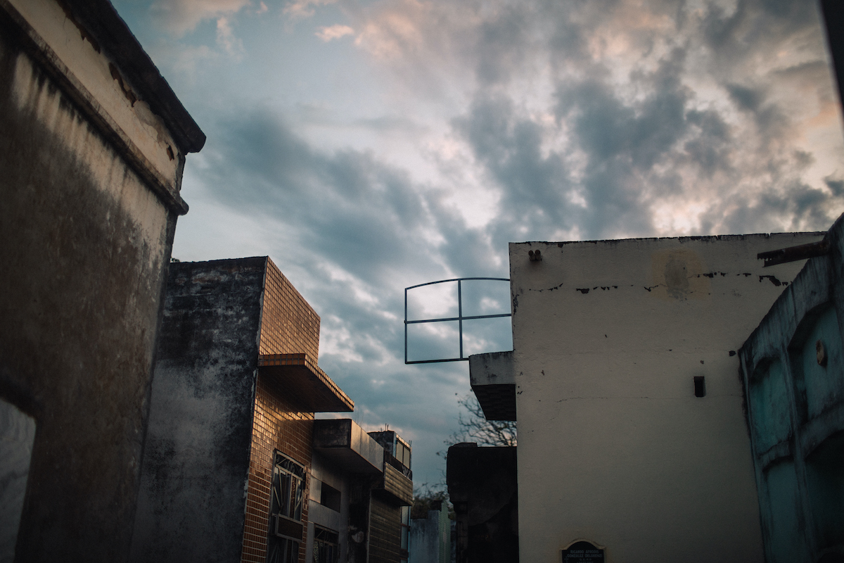 A photo of the view from the top of one of the vertical tombs, with the sky in the background.