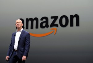 jeff bezos in front of amazon logo