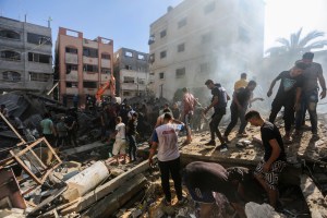 People search through buildings, destroyed during Israeli air raids in the southern Gaza Strip on November 6, 2023 in Khan Yunis, Gaza.