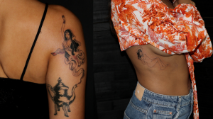 Photo of a woman from the back with a tattoo on her right arm of a teapot with legs and female genie coming out of it.