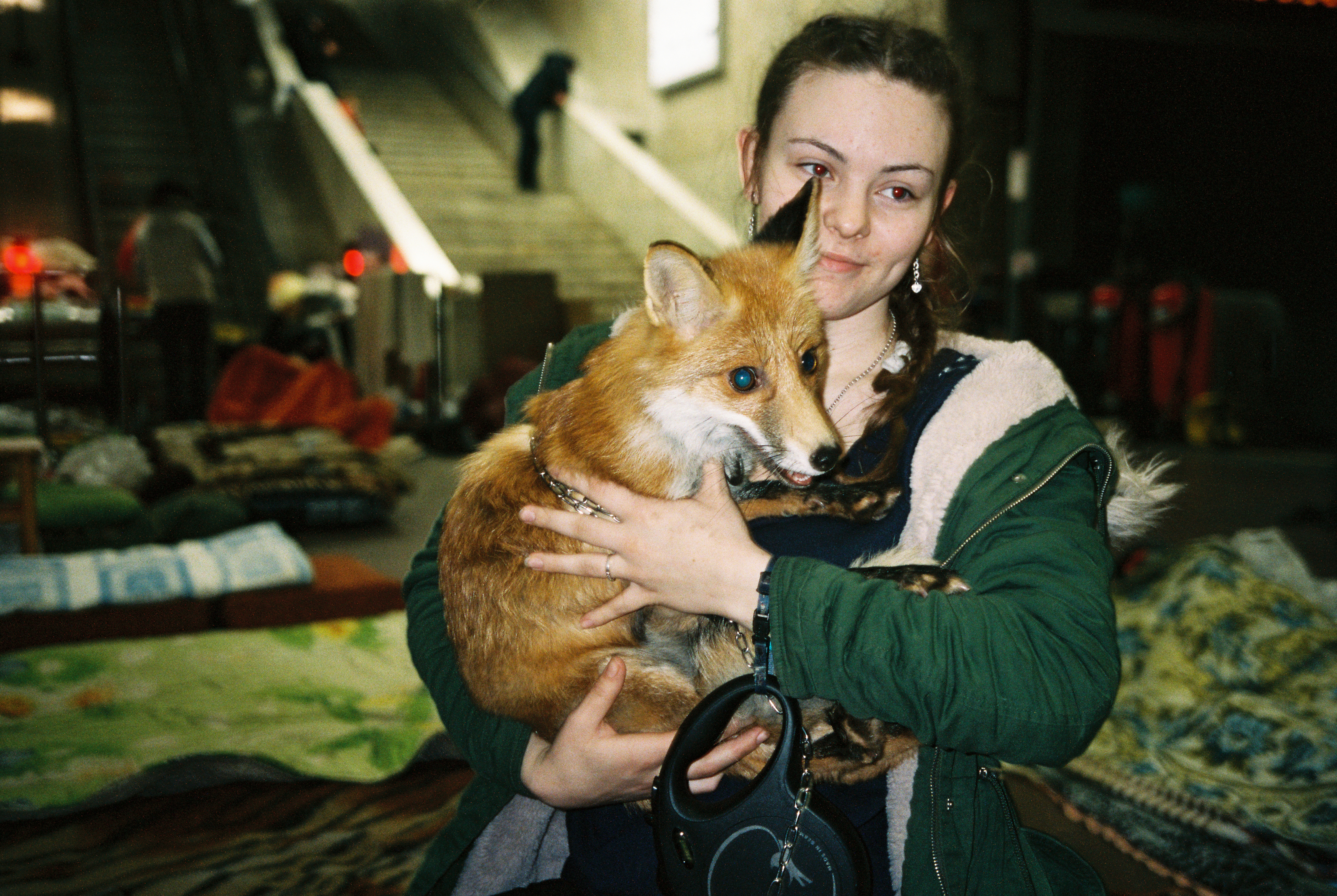 Kharkiv resident sheltering in underground metro station with pet fox