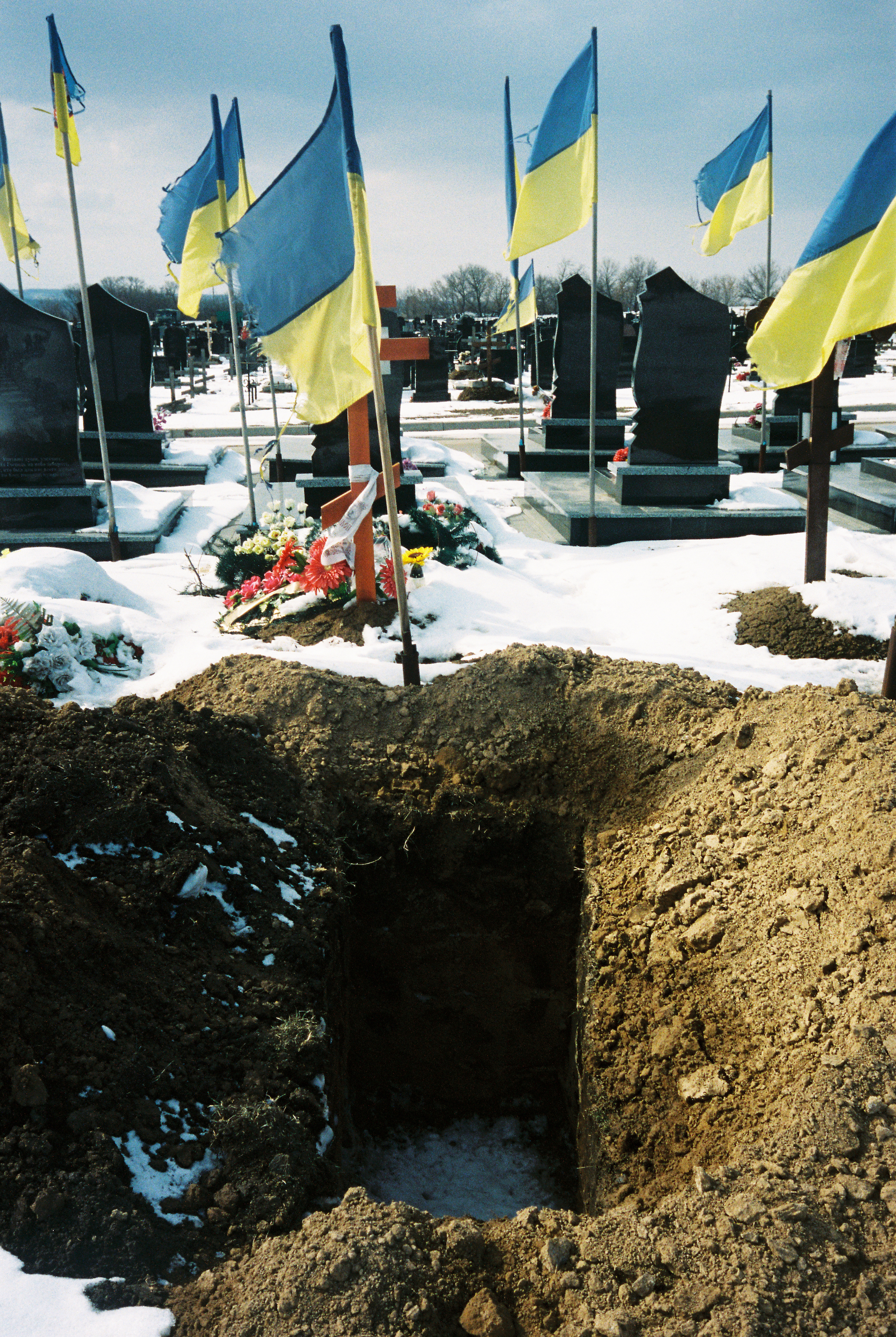 A freshly dug grave in the military section of a cemetery in the South of Kharkiv