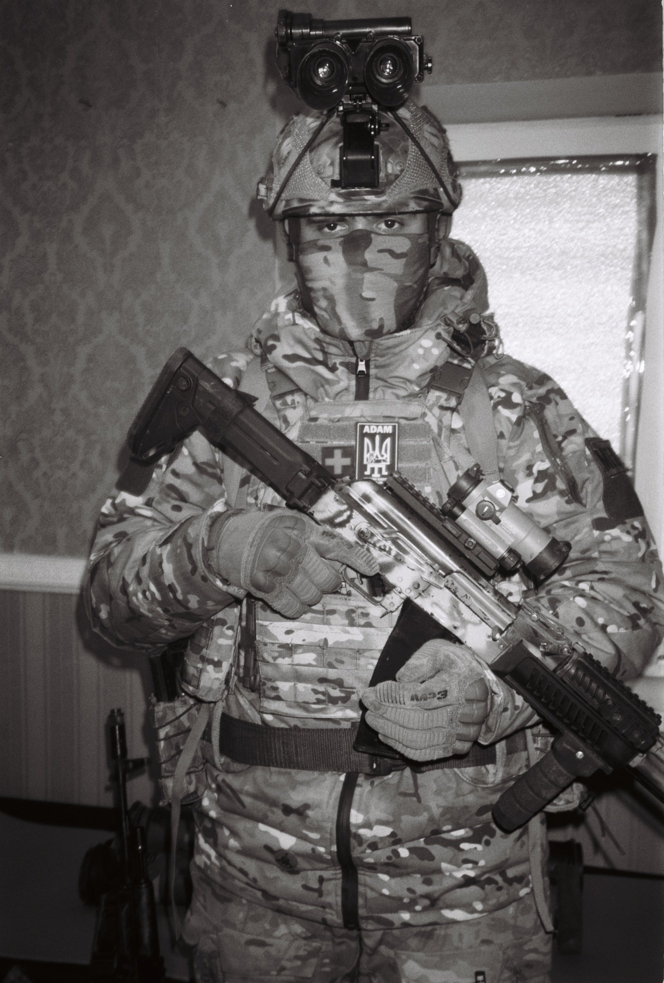 A Ukrainian soldier holds a gun in full fatigues