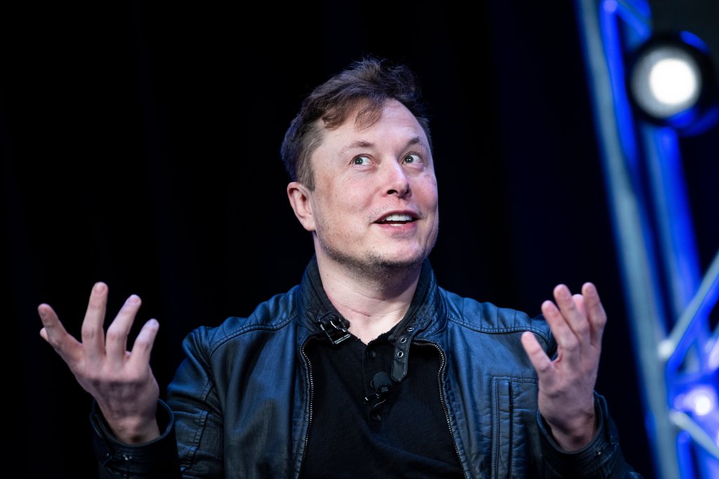 Elon waving his little fingers in the air onstage