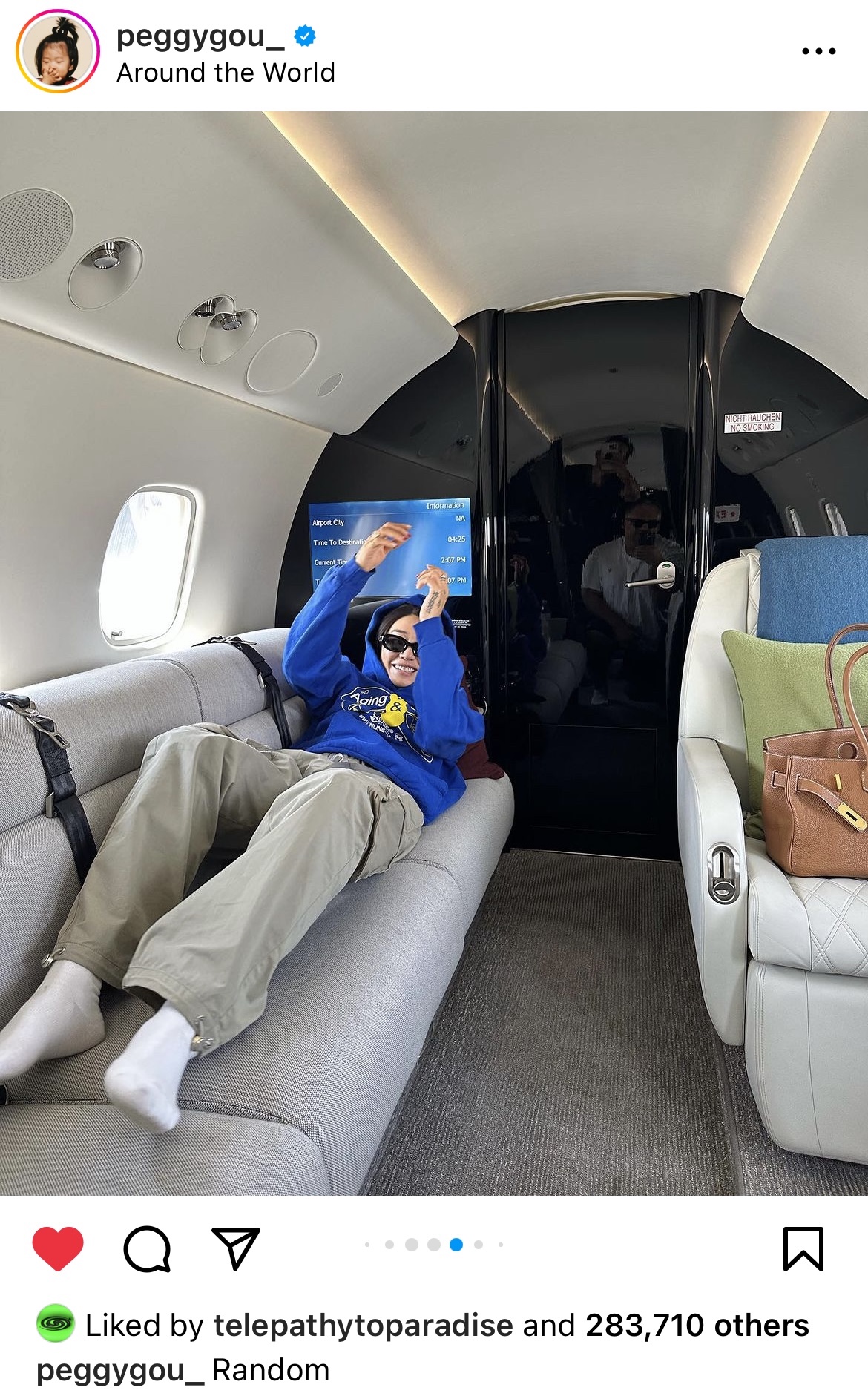 Peggy Gou on a private jet wearing sunglasses, hoodie and cargo pants