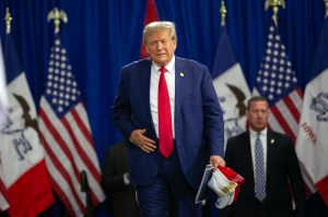 Former President Donald Trump enters from a side stage before he was set to speak to a crowd of supporters at the Fort Dodge Senior High School on November 18, 2023 in Fort Dodge, Iowa.