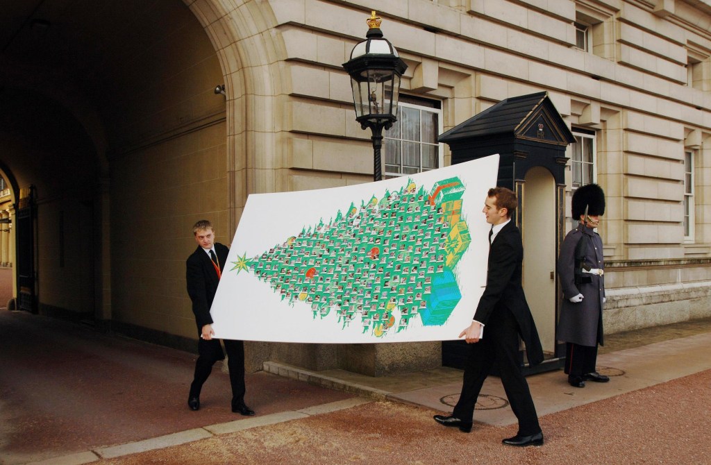 Footmen carry a giant Christmas card for Elizabeth II which was delivered in 2005 to Buckingham Palace in London