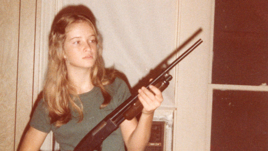 An archive photo of Ervil LeBaron's daughter Celia holding a gun.