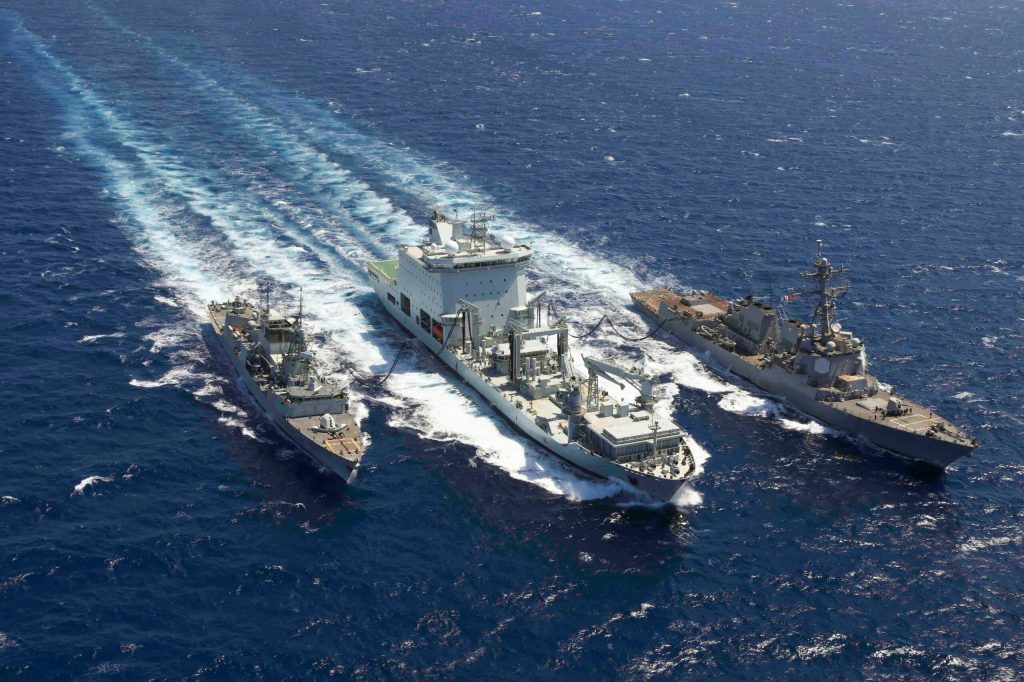 The USS Truxtun, right, and Canadian ships MV Asterix, middle, and Montreal conduct a replenishment in the Red Sea, May 3, 2023.