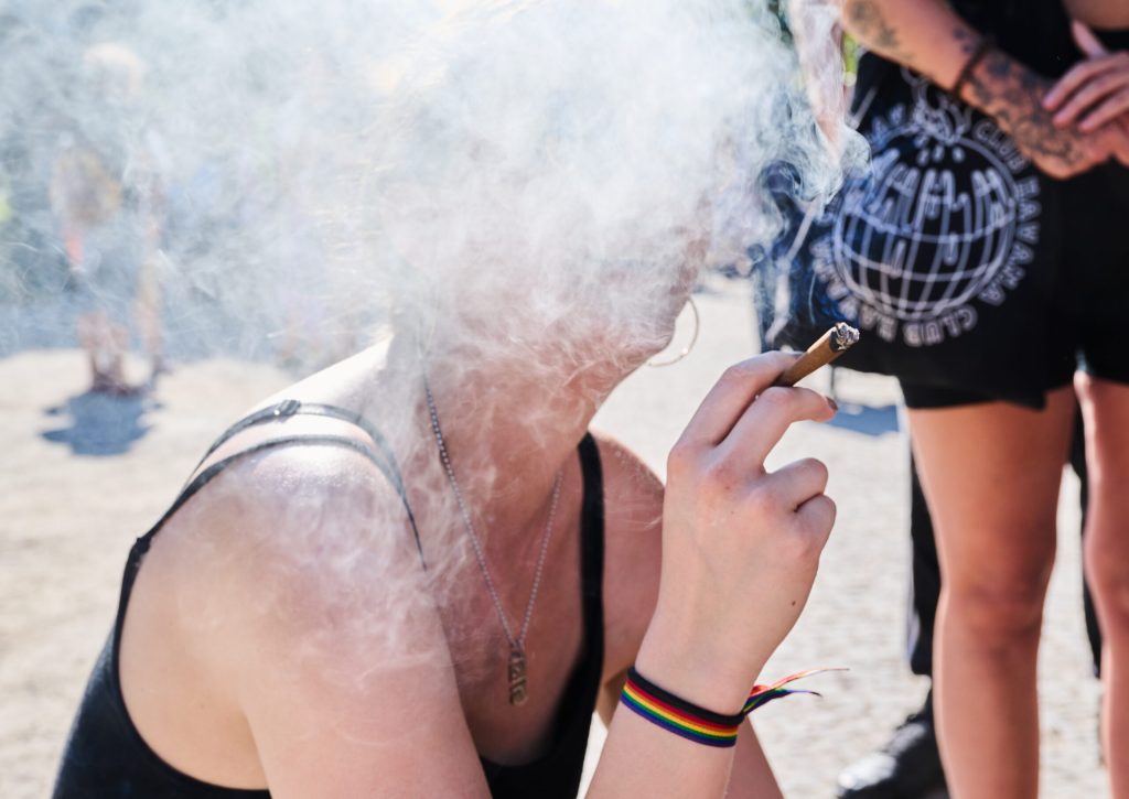 A woman smoking a fat joint at a hemp parade in 2021. S