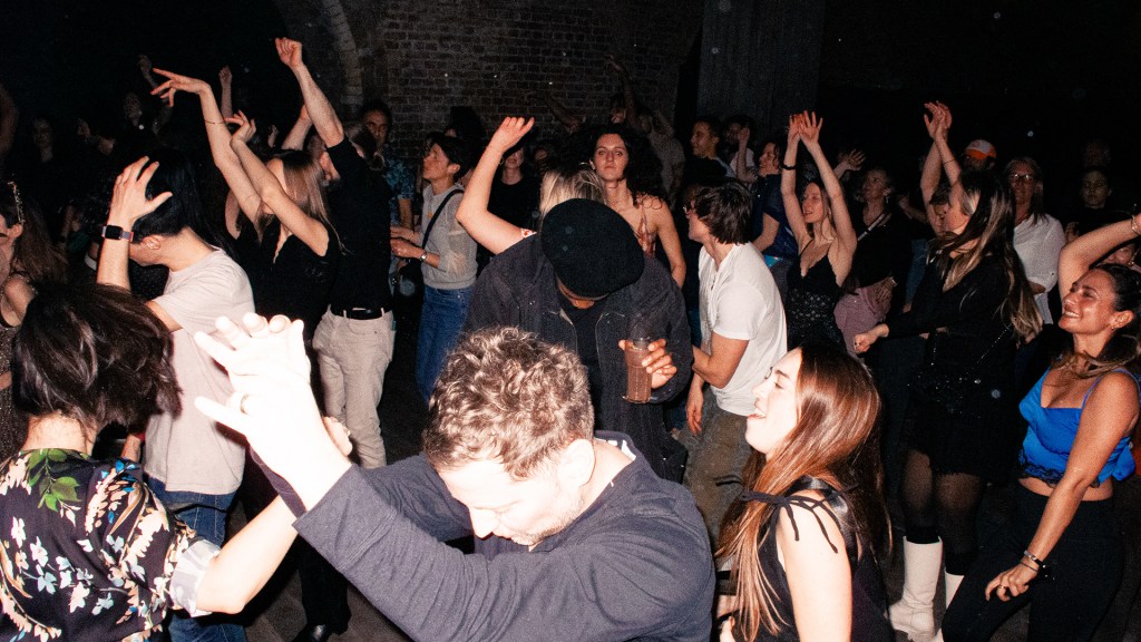 A photo taken above of a dancefloor filled with people dancing.