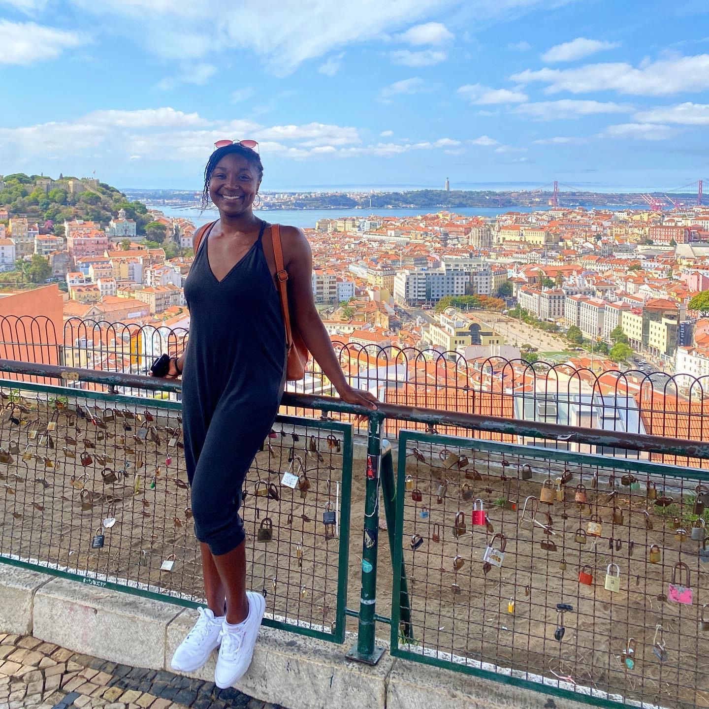 African-American digital nomad leaning against fence