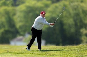 Former President Donald Trump follows his second shot during the pro-am prior to the LIV Golf Invitational - DC at Trump National Golf Club on May 25, 2023 in Sterling, Virginia.