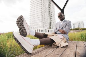 Black man in sunglasses wearing Perryco sneakers