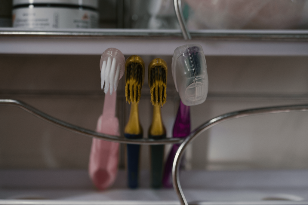 Four toothbrushes lined up in a row