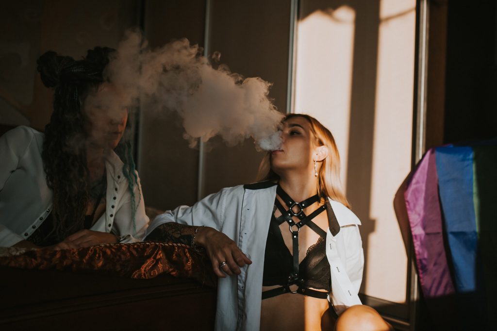 Two girls vaping in room