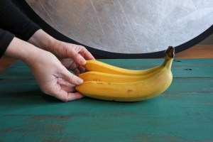 A person gently touches bananas