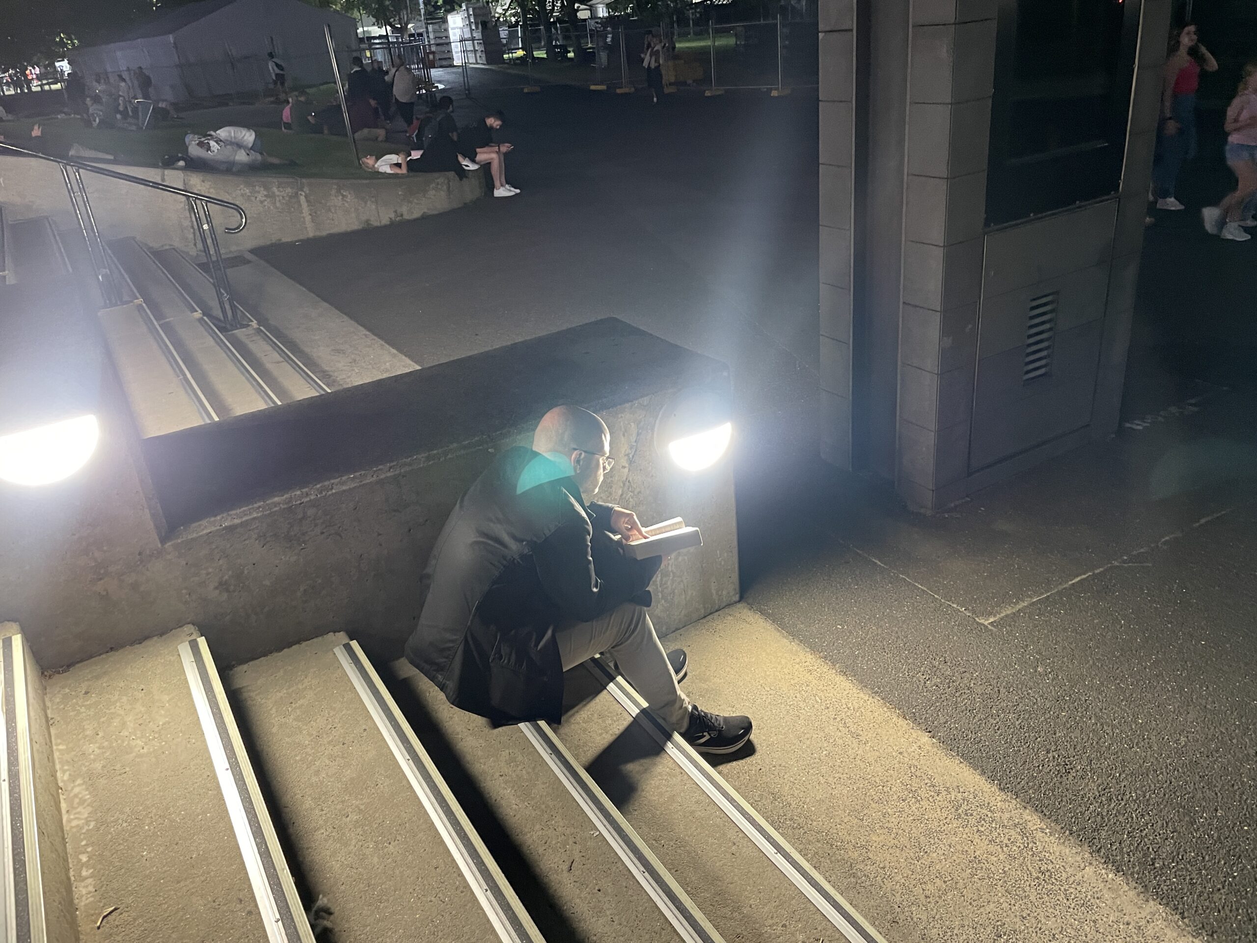 Person reading a book on steps