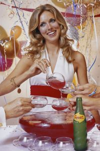 Woman at a party filling up a punch glass