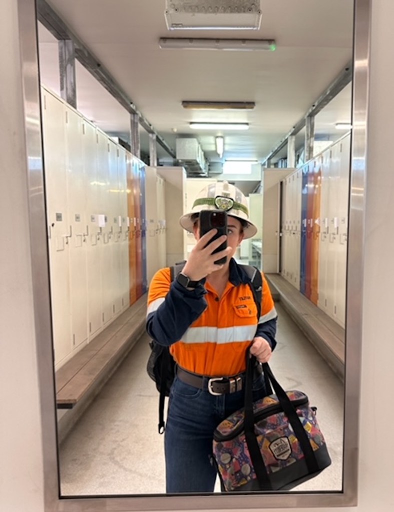 A woman at her mining job getting ready