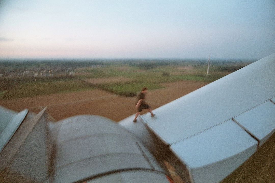 Man on top of wind turbine in Europe.