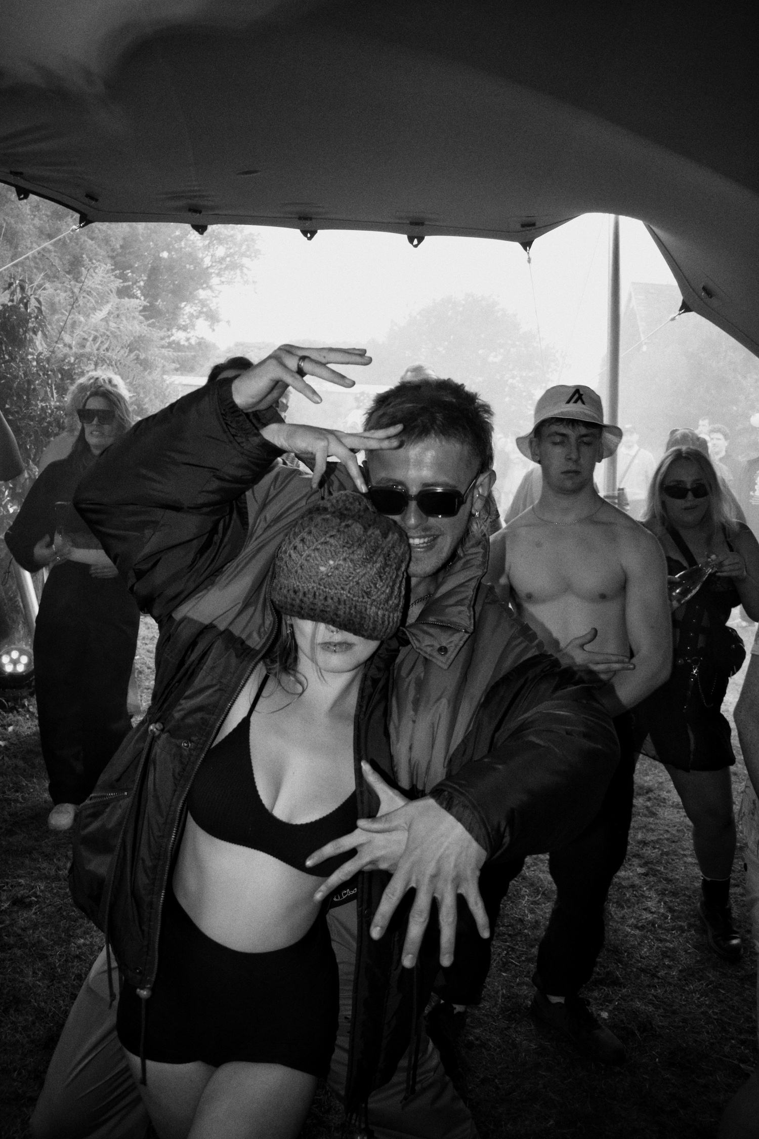 Two young people dancing in a rave tent.