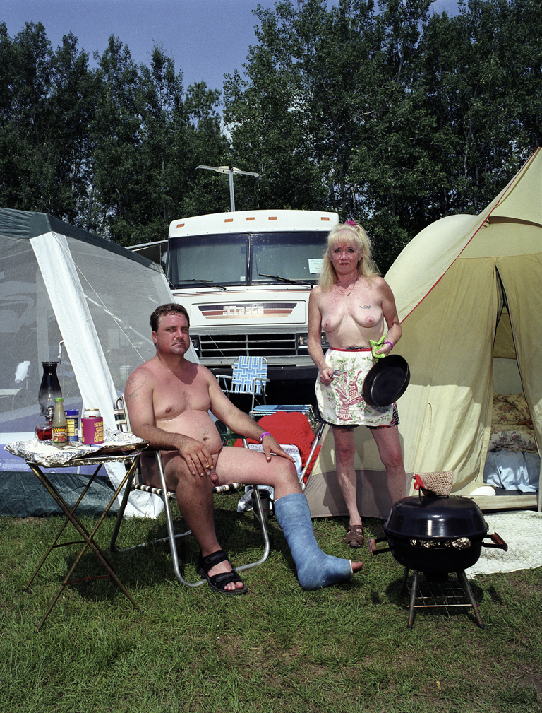 swingers at a campground man in a leg cast and woman topless grilling