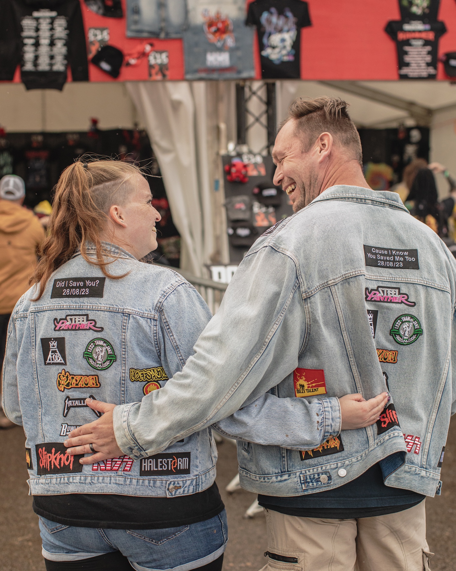 Two people in matching denim jackets with patches