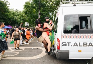 Two young people dance at Notting Hill Carnival 2024, in London, England, UK