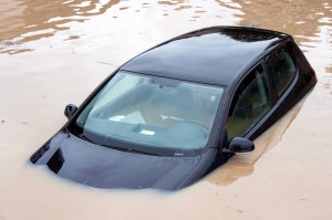 Damaged black car under the brown high water on flood, insurance issue of environmental climate change; Shutterstock ID 2383055547; purchase_order: vice.com; job: ; client: ; other: