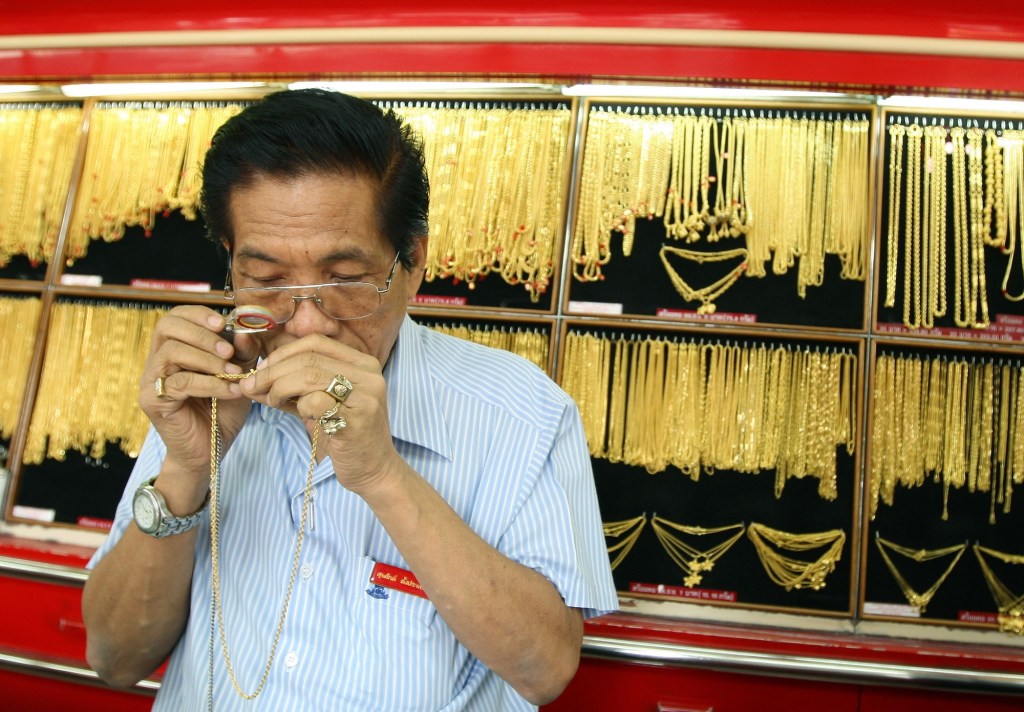 jeweler examining gold necklace