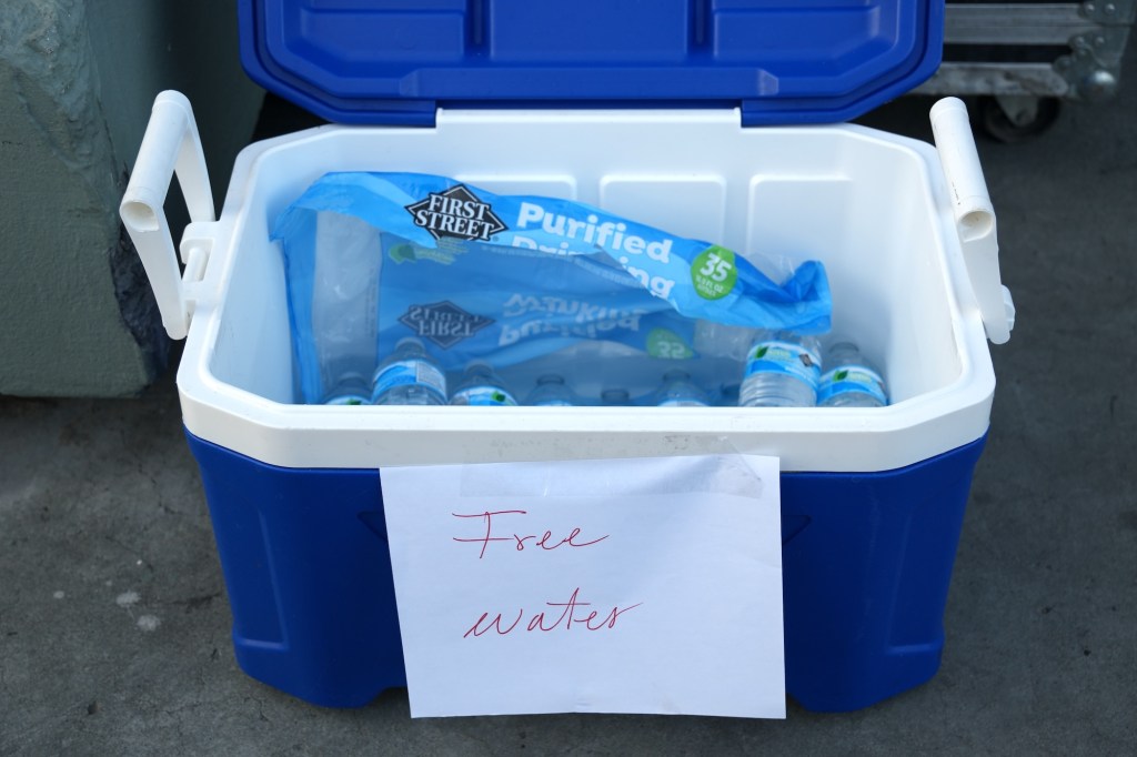 Plastic water bottles in a cooler marked free water