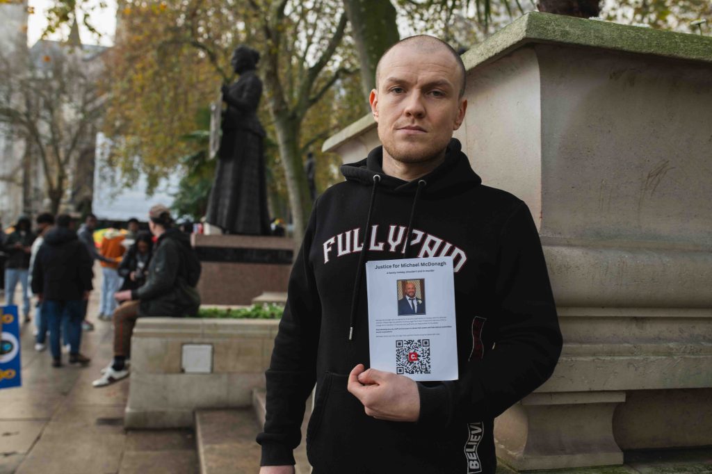 A man protests at a demonstration pushing for greater respect for the UK's Gypsy, Roma and Traveller communities, in central London in November 2024